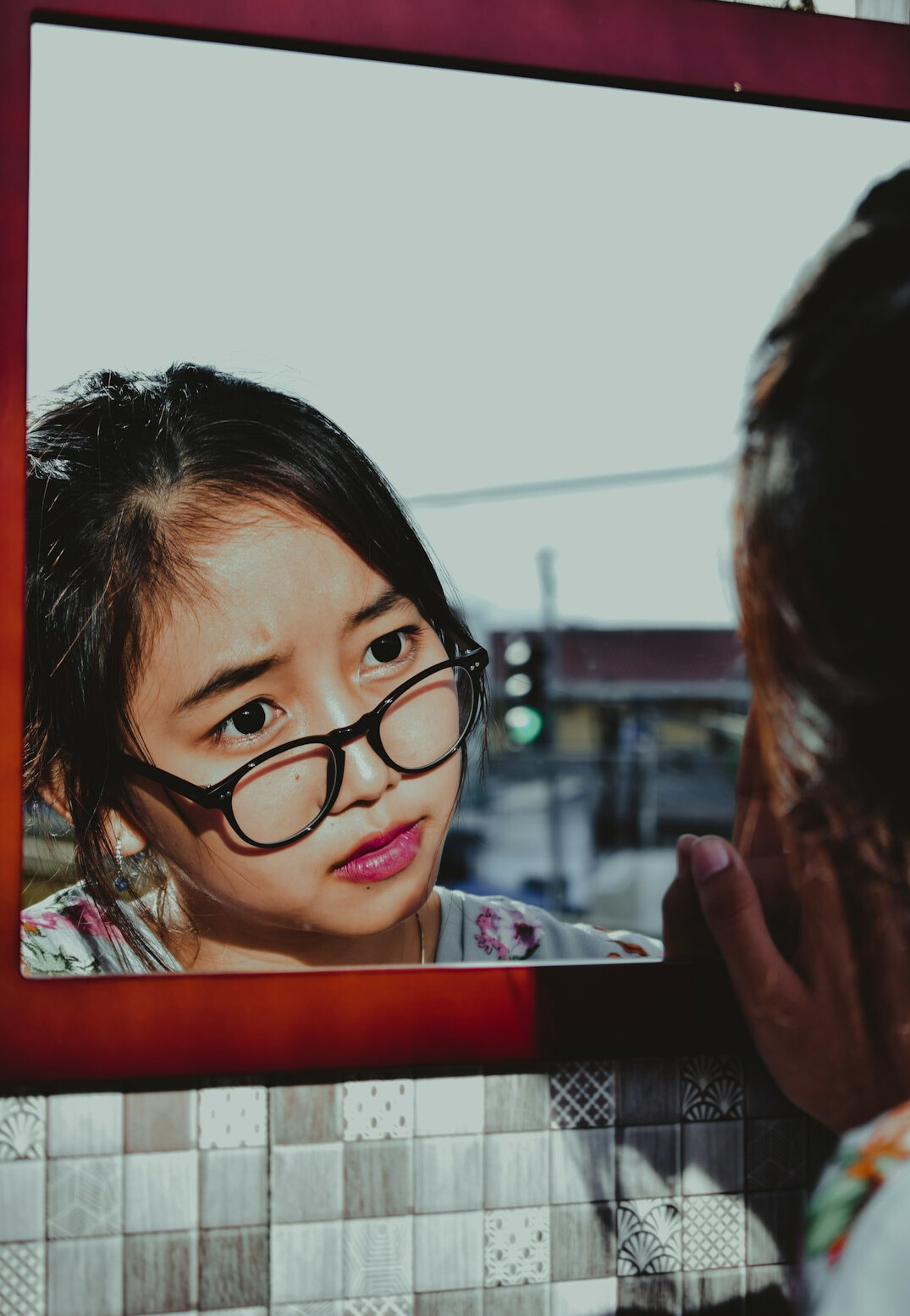 child looking at mirror